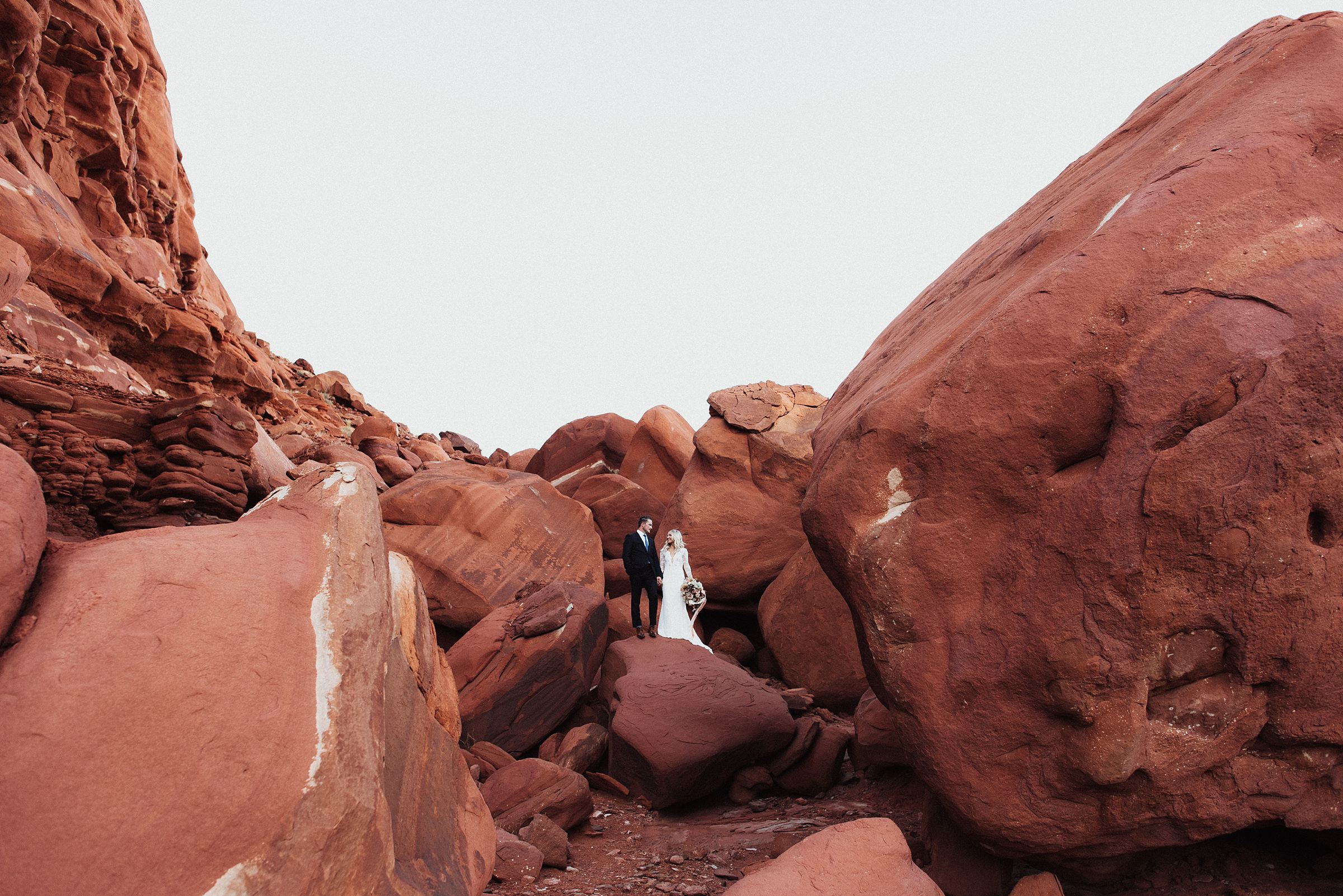 bride and groom on red rocks at dead horse point
